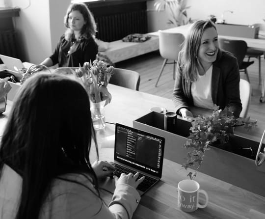 Photo of people smiling in an office